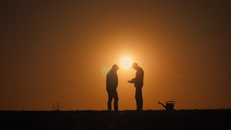 farmers discussing at sunset