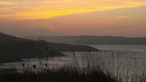 static shot of peaceful seascape and mountains at