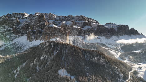 aerial view of snowy mountain range in selva di val gardena, italy