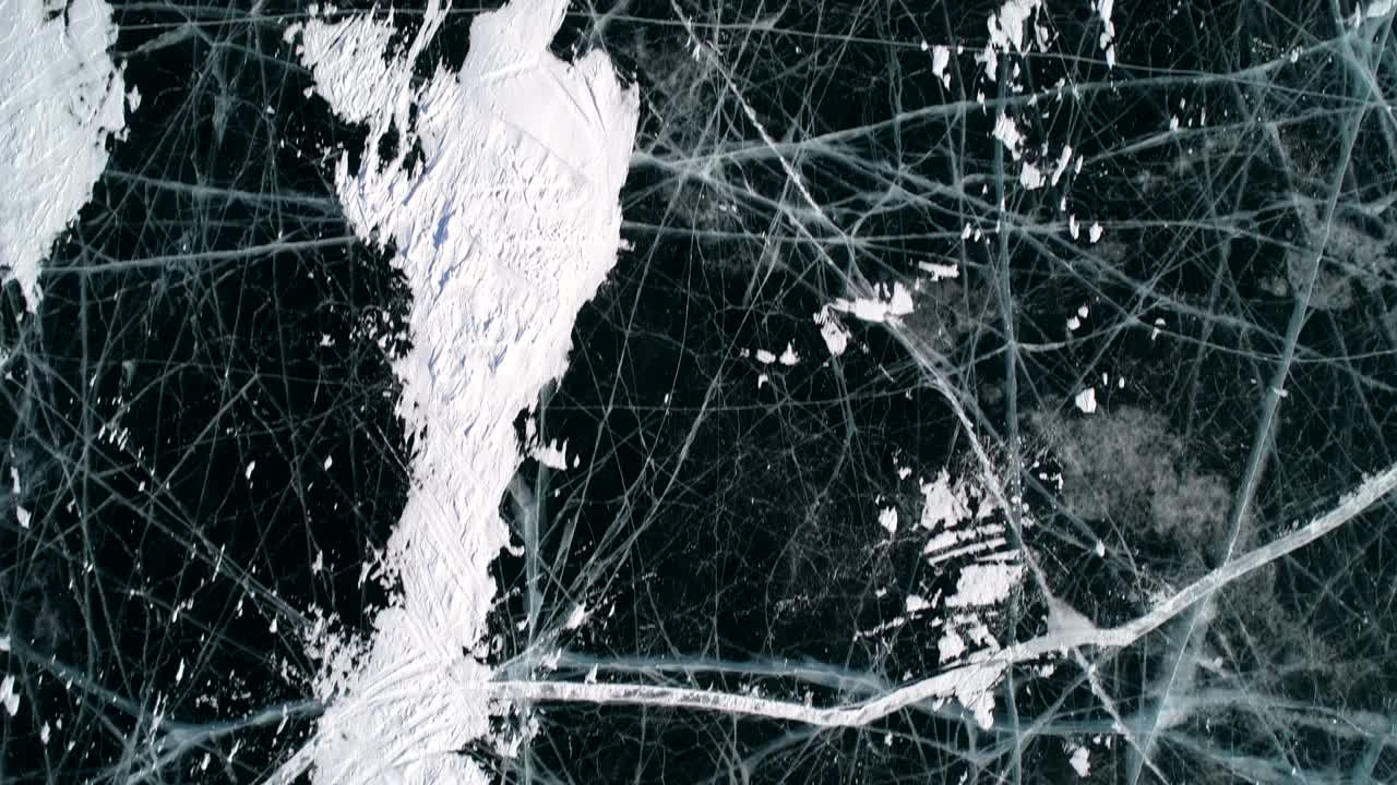 воздушный над голубым прозрачным прозрачным льдом с трещинами и пузырьками внутри. замороженное озеро байкал. естественная достопримечательность. зимний пейзаж. популярное туристическое направление. вид сверху вниз.