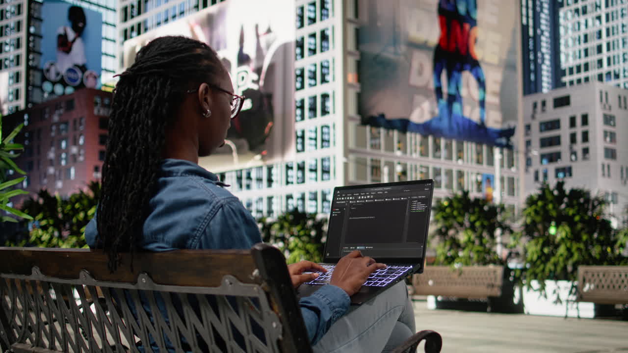Writing code on laptop, implementing programming language, software developer