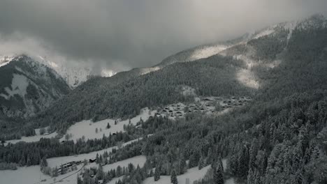 Pueblo-De-Montaña-Con-Cabañas-En-Un-Idílico-Paisaje-Nevado-Con-árboles-Y-Nieve