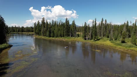 drone shot passing the at bridge at big springs river and seeing some rafters