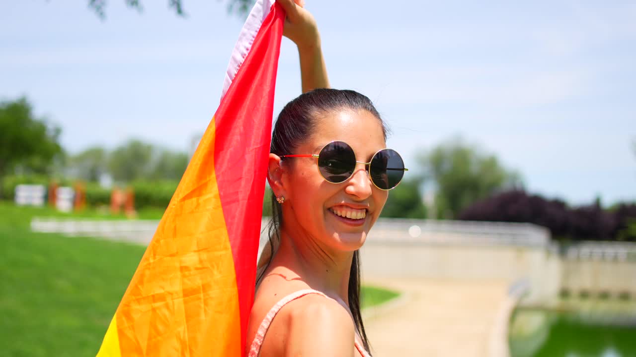 Woman with LGBTQ Pride Flag in Park