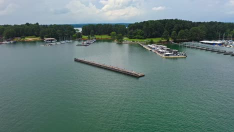 Aerial-flyover-Lake-Lanier-with-parking-boats-at-port-and-forest-in-background---Georgia,-Atlanta,-Countys-Hall