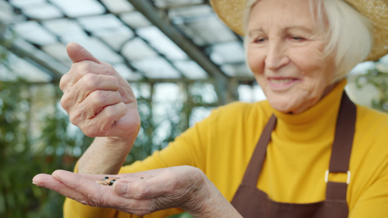 Senior Woman Planting Seeds in Greenhouse
