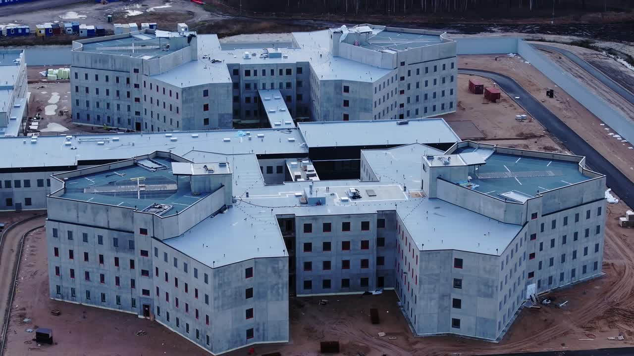 Modern correctional facility under construction, aerial of ongoing work, PRISON