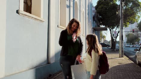 A Mother and Daughter's Heartwarming Moments on a City Sidewalk