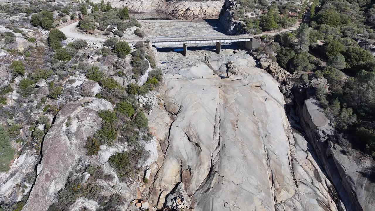 Mammoth Pools Reservoir during the summer near empty DOLLY FORWARD TILT UP REVEAL