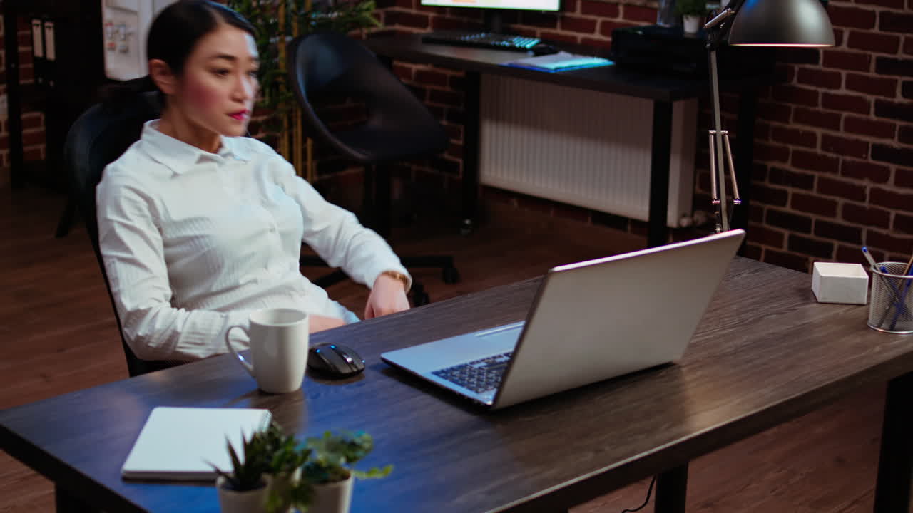 Tired businesswoman looking at watch, annoyed by time passing too slow