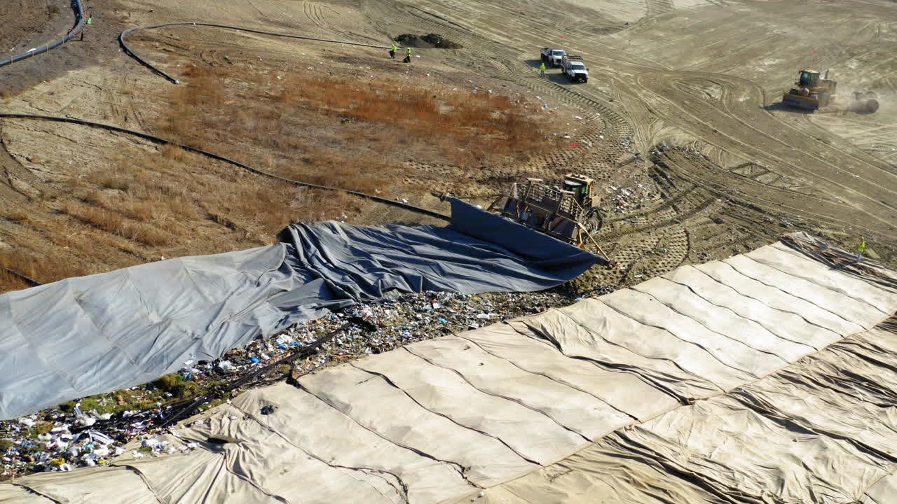 Aerial View of Landfill Operations with Heavy Equipment and Workers
