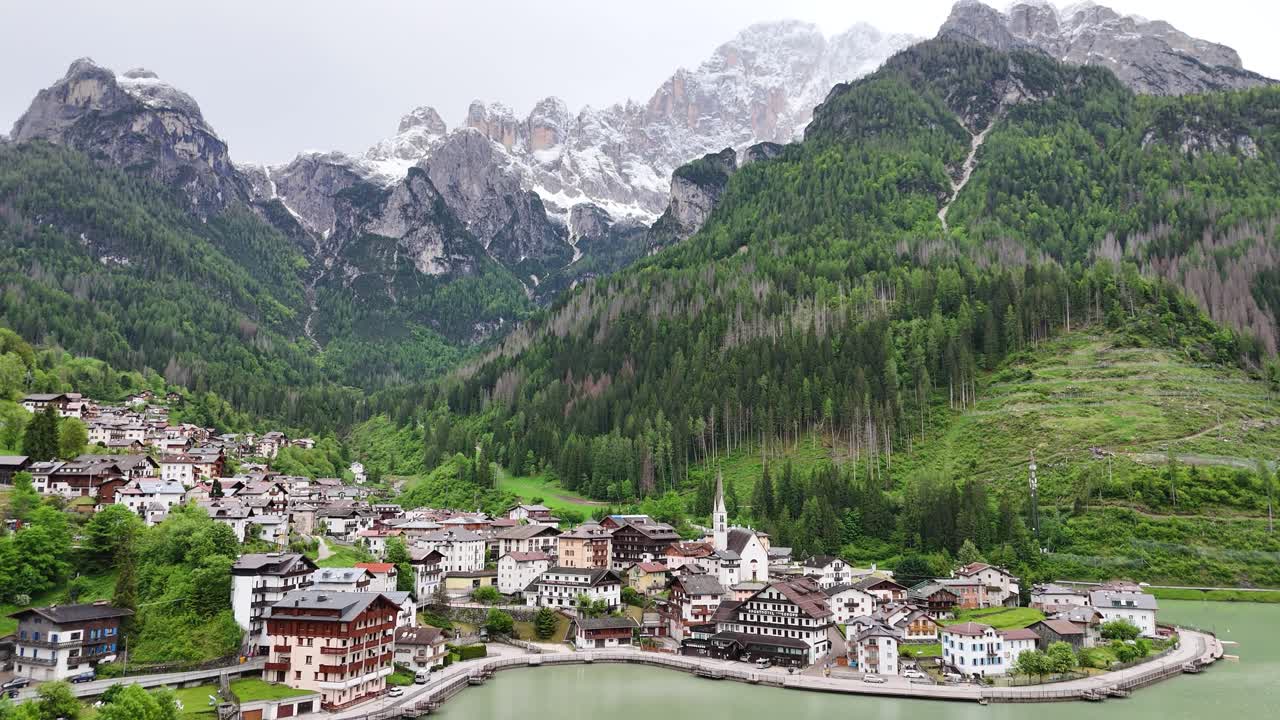 Drone slowly pulls back to reveal Alleghe and Dolomites landscape