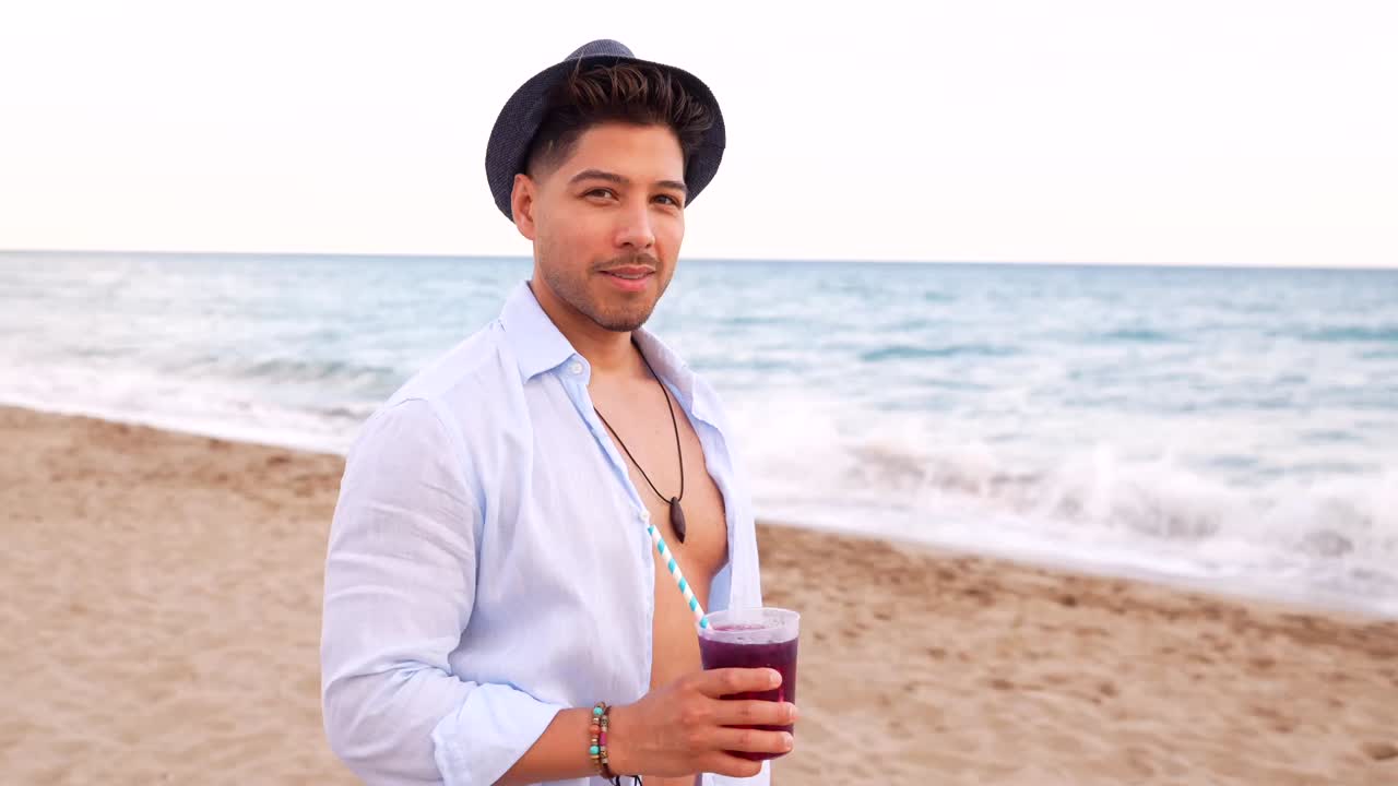 Man relaxing on a beach with a drink