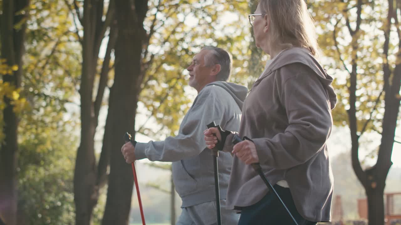 pareja de ancianos caucásicos nórdicos caminando en el parque