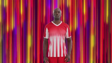 animation of colourful trails over african american male soccer player