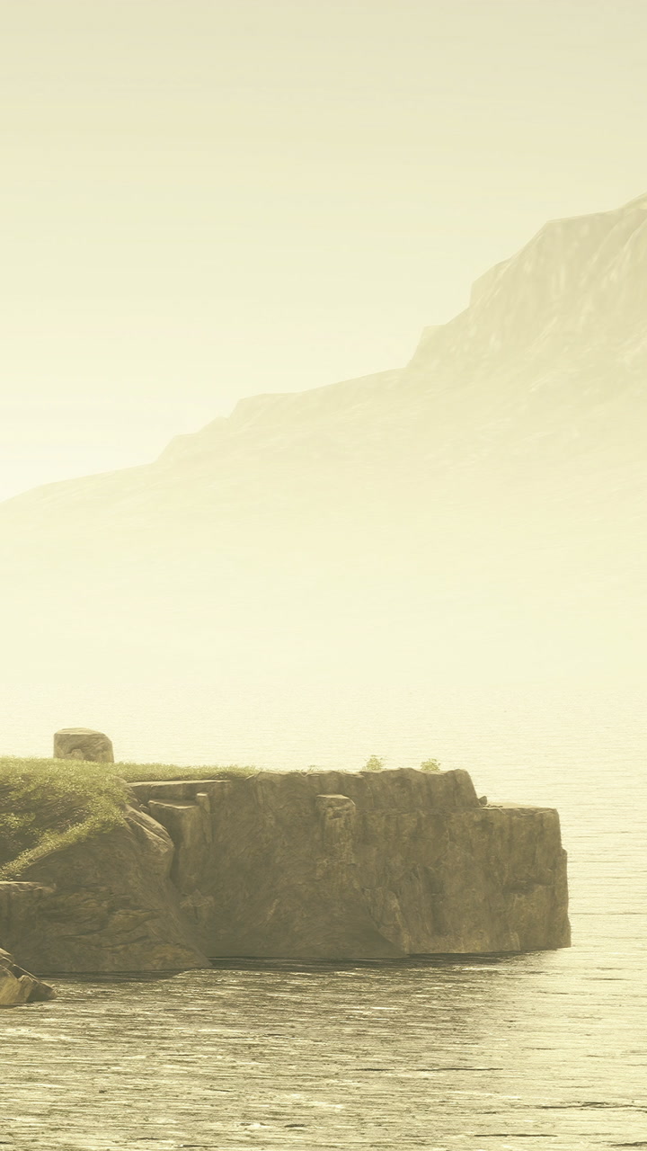Calm waters reflect quiet mountains during golden hour near rocky shore