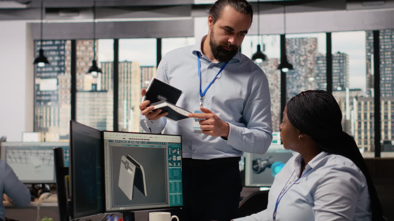 Team Leader Supervising Work Done By Engineer Creating Solar Cell Energy Device