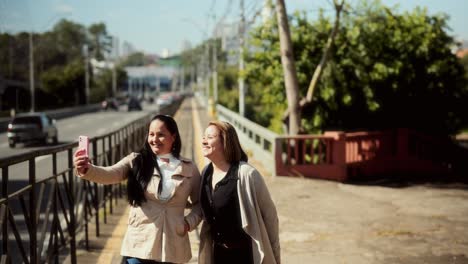 friends enjoying a walk and taking selfies in the city