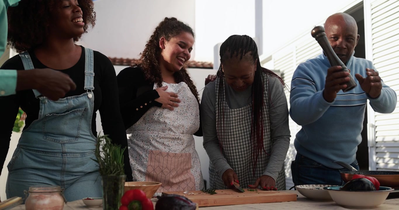 Happy African American Family Cooking Together Outdoors