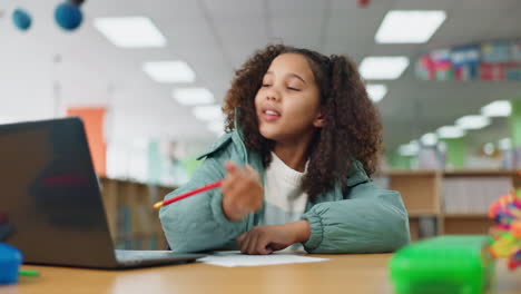 girl studying with laptop in classroom