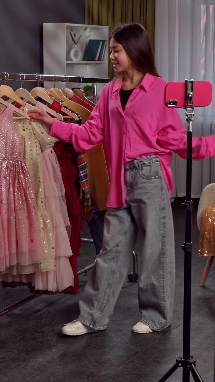 Teen Girl Trying On Kids' Dresses