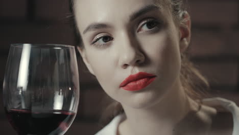 Proud-woman-with-red-wine-glass-looking-away.-Portrait-woman-with-red-wine