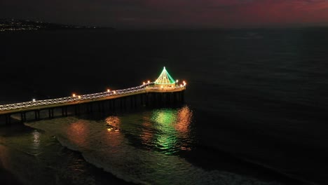 nighttime view of manhattan beach pier - aerial drone shot