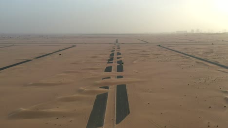 4k drone footage, a road between desert, dubai’s half desert road, geological landscape of high dune desert in the united arab emirates, drone videos