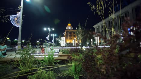 night cityscape with illuminated buildings and public plaza