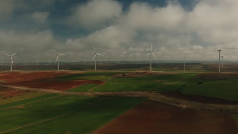 aerial shot towards a line of wind generators