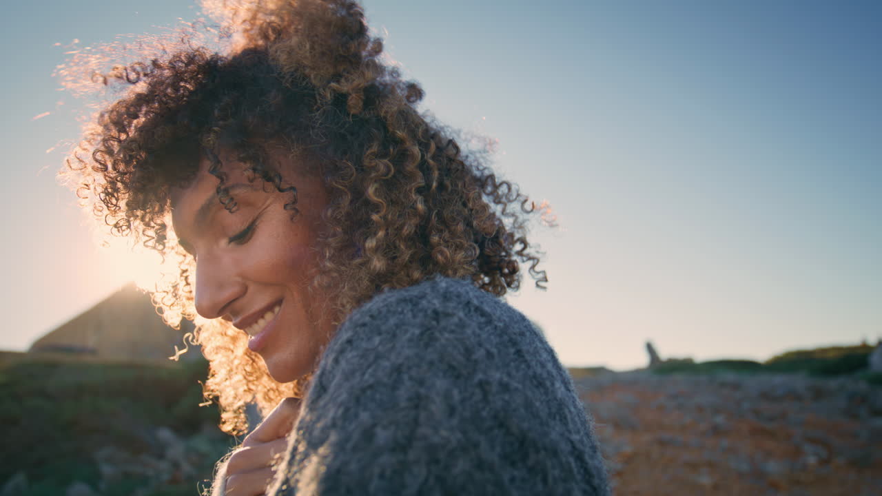 Curly model posing sunny nature portrait. Happy wavy hair woman smiling camera