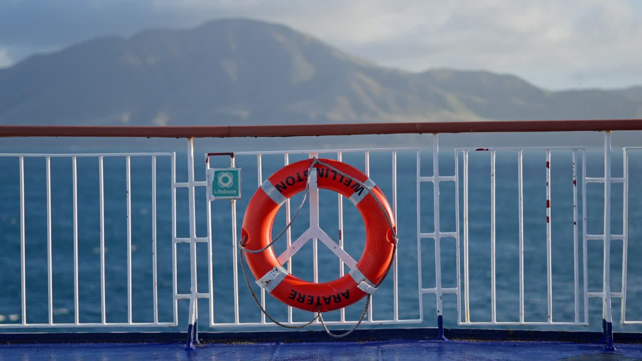 Ferry Lifebuoy with Calm Ocean and Mountain View in New Zealand