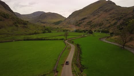 Car-Driving-on-Road-toward-Converging-England-Mountains-on-Overcast-Day