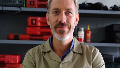 mechanic standing with arms crossed