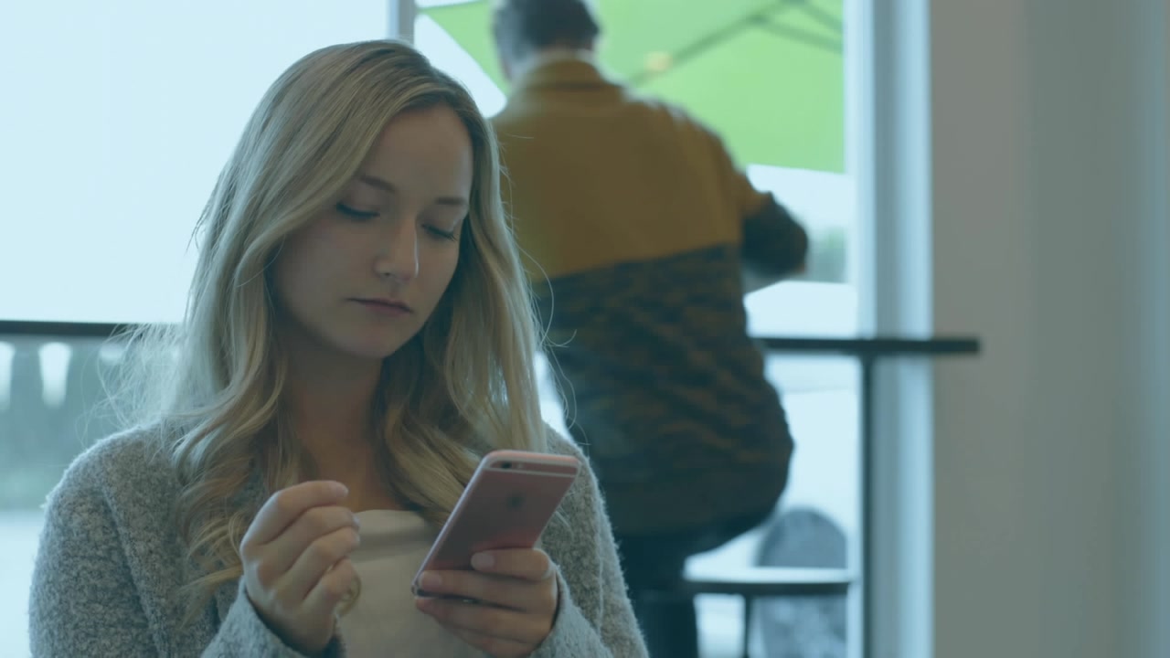 Animation of purple screen with circle and stripes over businesswoman using smartphone