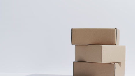 video of stacked cardboard boxes with copy space over white background