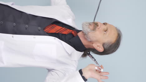 Vertical-video-of-Dancing-old-doctor.-Happy-and-cute.