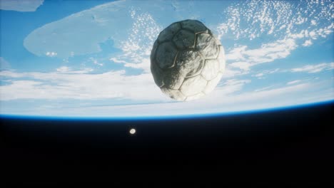 old soccer ball in space on earth orbit