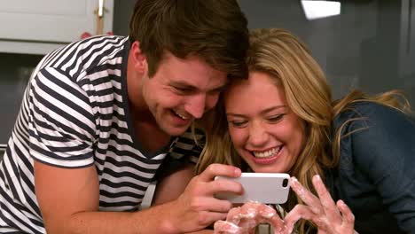 smiling couple preparing pizza