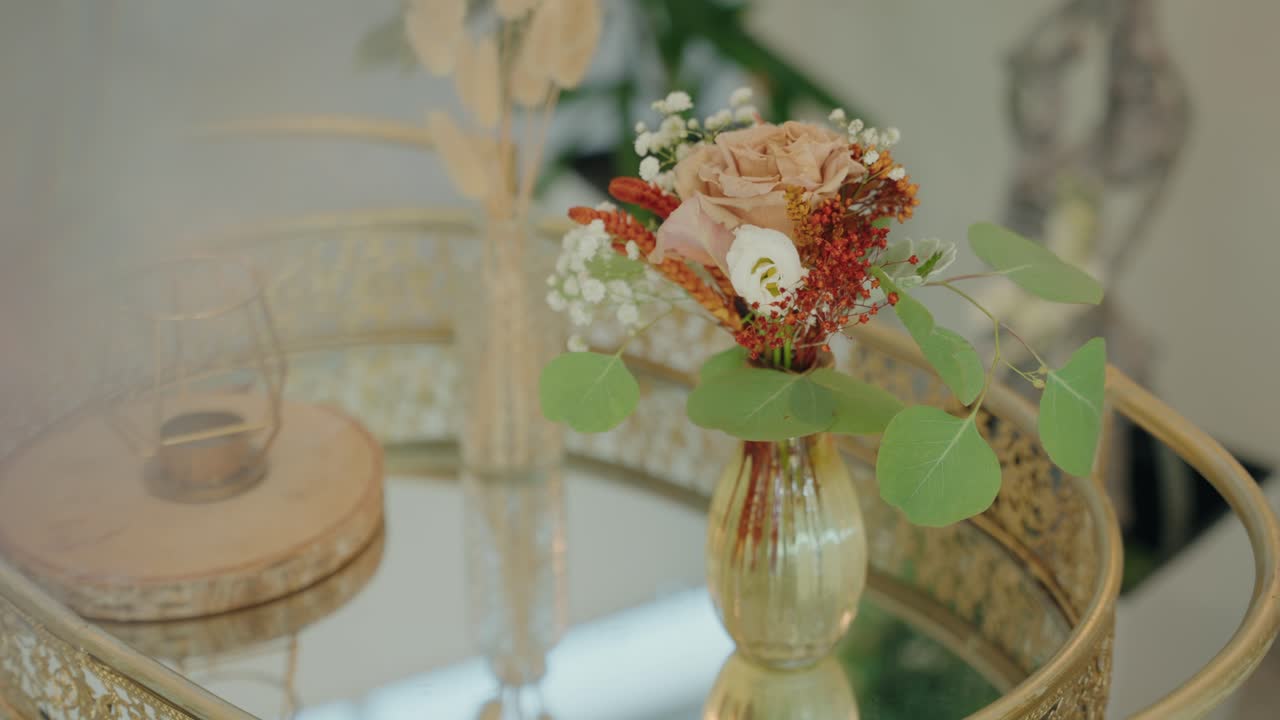 soft light on wedding flowers with gold vase on elegant mirrored tray