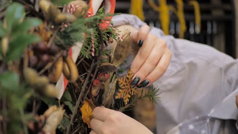 florist at work. how to make christmas wreath with floral arrangement. step by step, tutorial