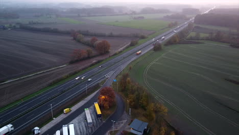 high aerial top down shot of parking area with trucks beside german motorway