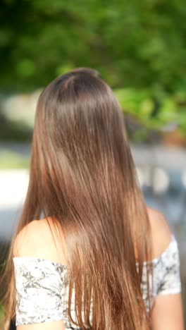 young woman with long hair outdoors