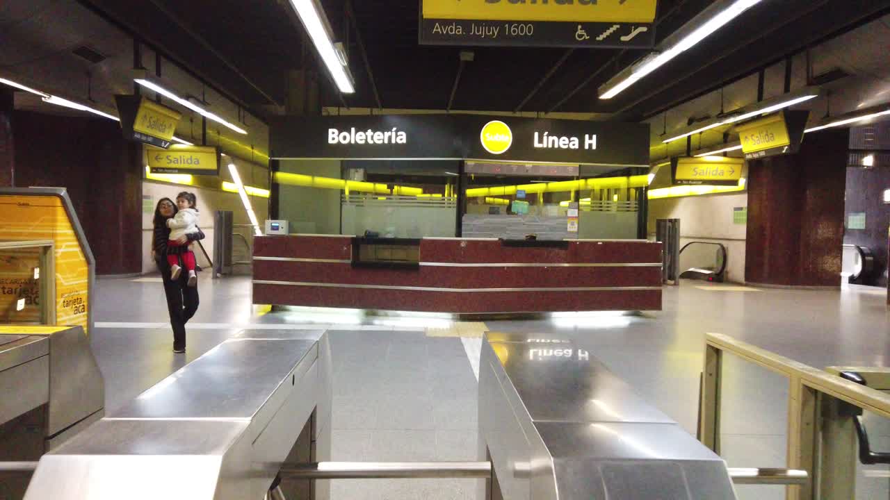 POV Walk inside Line H underground subway of buenos aires argentina, architecture and turnstiles, ticket shop, people traveling by