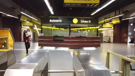 pov walk inside line h underground subway of buenos aires argentina, architecture and turnstiles, ticket shop, people traveling by