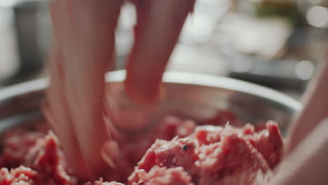 hand mixing minced meat and spices