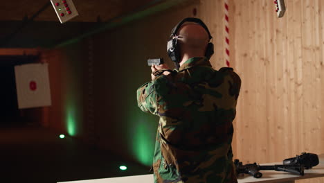 military man in firing range checking to see if he shot bullseye