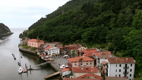 Drone-shot-of-colorful-houses-of-the-fishing-town-of-Pasajes-de-San-Juan-near-Cantabrian-Sea