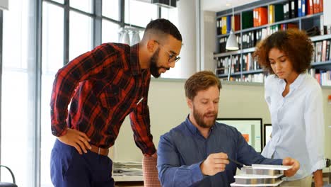 architects discussing over building model at desk 4k