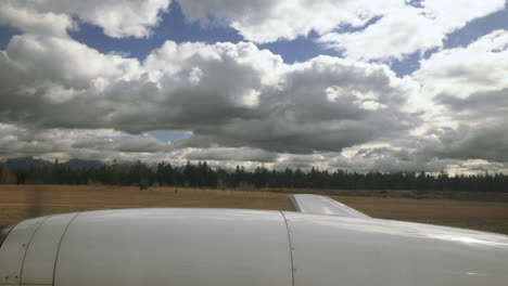 propeller plane travelling quickly down the runway on an airport